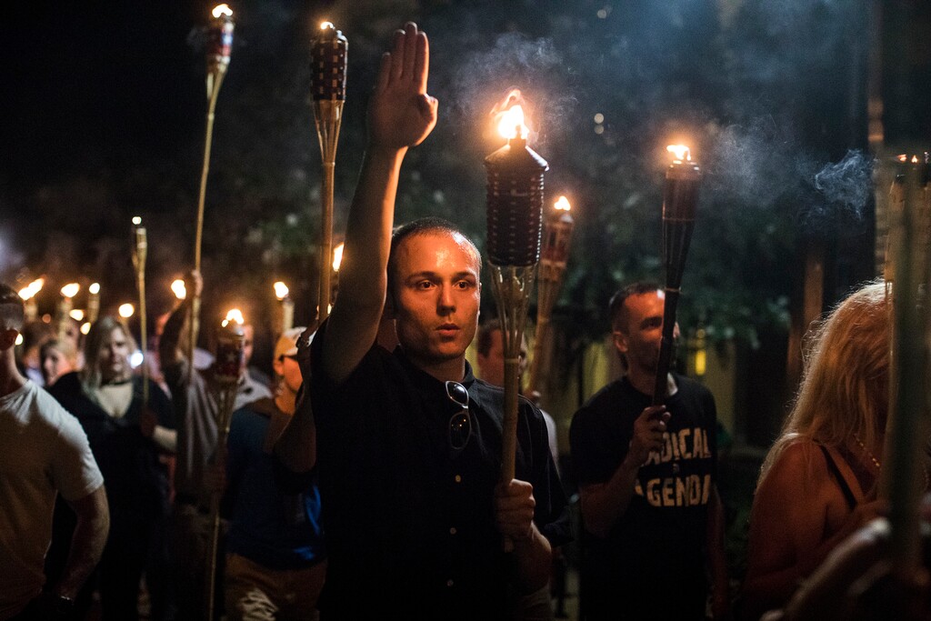 (Edu Bayer | The New York Times)

A man raises his arm in a Nazi salute at a gathering of white nationalists in Charlottesville, Va., on Aug. 11, 2017.