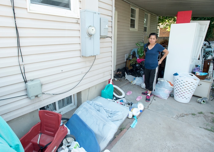 (Rick Egan  |  The Salt Lake Tribune)  Ana Holt takes a look at all of her belongings on the back patio of her home. Nearly everything that was in the basement needs to be thrown away, after sewage water flooded the basement of her home on 2100 South. Tuesday, August 1, 2017.