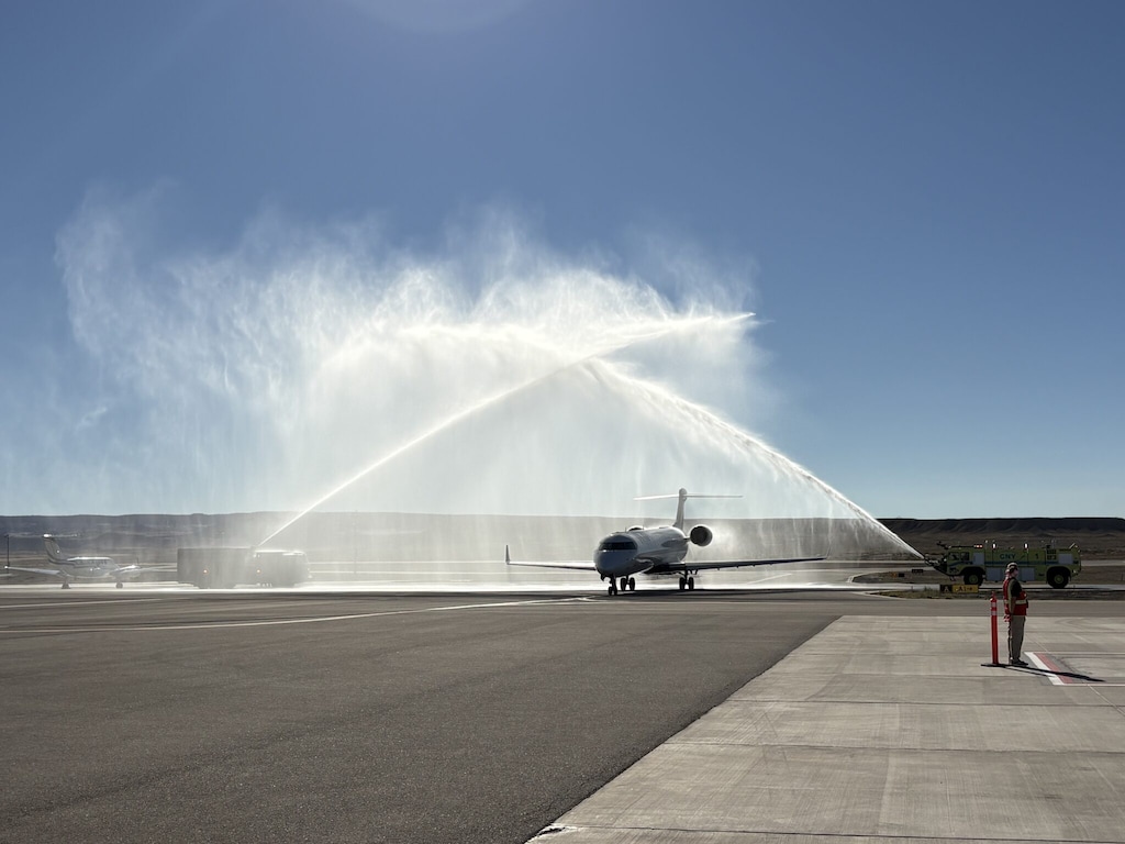 (Andrew Christiansen | The Times-Independent) Fire trucks welcome the inaugural SkyWest-operated Delta Connection flight from Salt Lake City with a water salute Oct. 1 at Canyonlands Regional Airport.