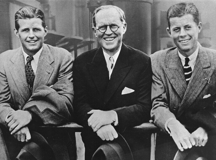 FILE - In this 1938 file photo, John F. Kennedy, right, poses aboard an ocean liner with his father Joseph P. Kennedy, center, U.S. Ambassador to Great Britain, and brother Joseph P. Kennedy Jr., left. Monday, May 29, 2017 marks the 100-year anniversary of the birth of John F. Kennedy, who went on to become the 35th President of the United States. (AP Photo, File)