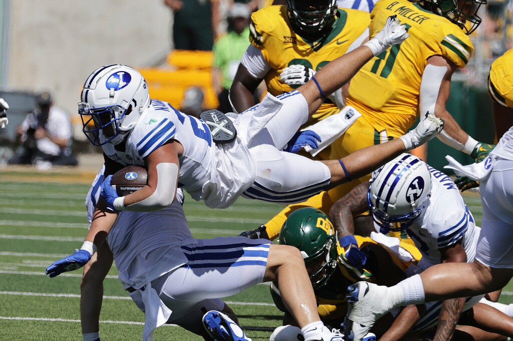 Brigham Young running back Enoch Nawahine leaps through the Baylor defense in the first half of an NCAA college football game, Saturday, Sept. 28, 2024, in Waco, Texas. (AP Photo/Jerry Larson)
