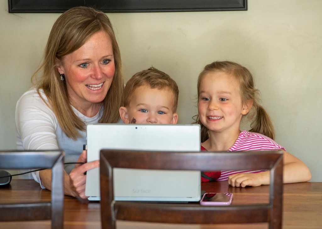 (Rick Egan  |  The Salt Lake Tribune)  Highland Park kindergarten teacher Shannon Hoover is joined by her children, 3-year-old Will, and 5-year-old Kate, as she talks to her kindergarten class on a Zoom call at her home, Thursday April 9, 2020