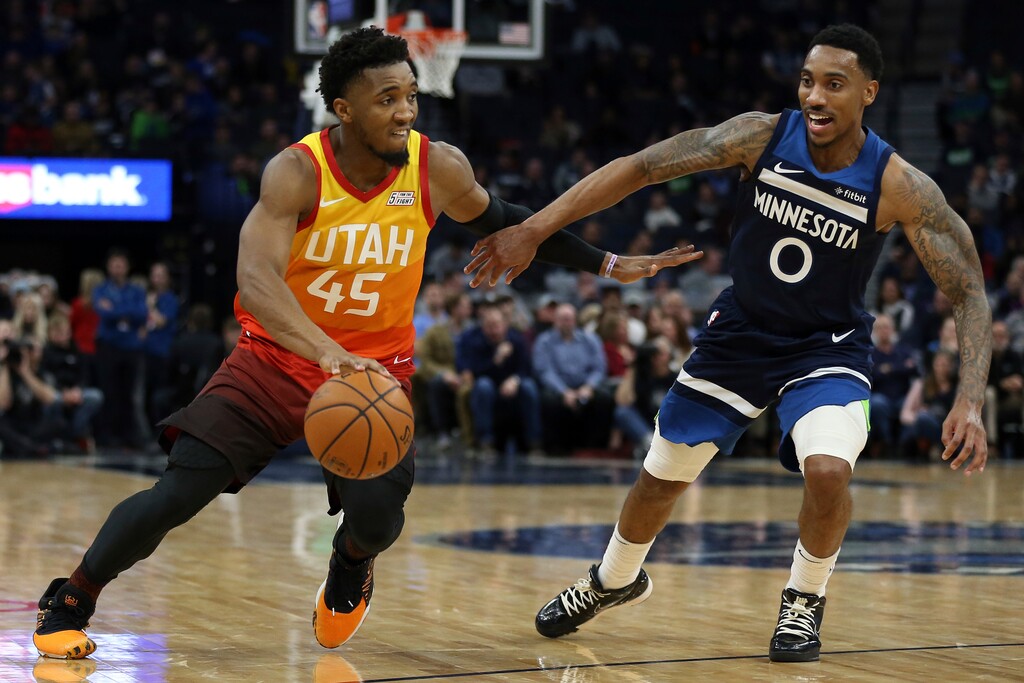Utah Jazz's Donovan Mitchell controls the ball against Minnesota Timberwolves' Jeff Teague in the first half of an NBA basketball game Wednesday, Dec. 11, 2019, in Minneapolis. (AP Photo/Stacy Bengs)