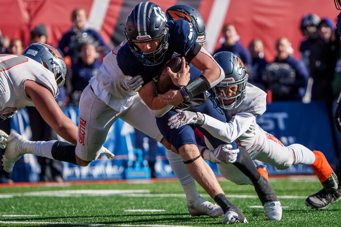 (Trent Nelson  |  The Salt Lake Tribune) Corner Canyon's Isaac Wilson (1) is tackled with three minutes left in the fourth quarter, effectively ending the game, as Corner Canyon faces Skyridge in the 6A high school football championship game at Rice-Eccles Stadium in Salt Lake City on Friday, Nov. 18, 2022.