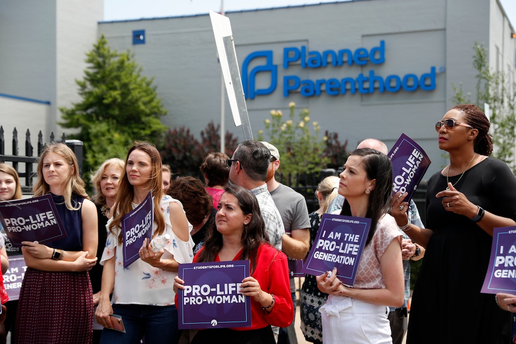 In this June 4, 2019, file photo, Anti-abortion advocates gather outside the Planned Parenthood clinic in St. Louis. Taxpayer-funded family planning clinics must stop referring women for abortions immediately, the Trump administration said Monday.