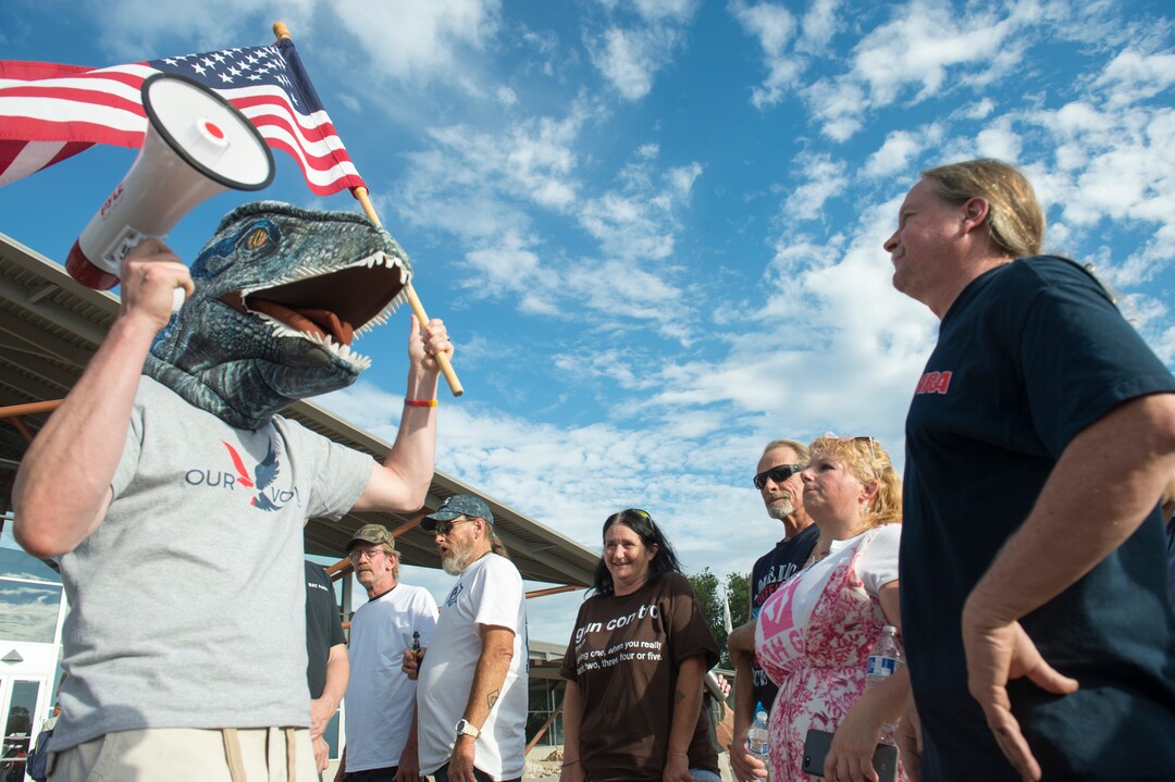 (Rick Egan  |  The Salt Lake Tribune)     Joshua  Cameron (left) wears a reptile mask to prove a point, as he argues with life-long gun owner Mark Stewart before a town hall meeting in Sandy, where survivors from the Florida school shooting held a forum with Utah students involved with the March for Our Lives movement, Saturday, July 14, 2018.