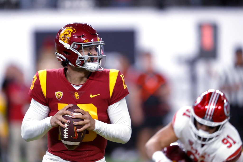 (Steve Marcus | AP) Southern California quarterback Caleb Williams (13) looks for an open receiver during the first half of the team's Pac-12 Conference championship NCAA college football game against Utah on Friday, Dec. 2, 2022, in Las Vegas. Utah defensive end Gabe Reid (91) is at right.
