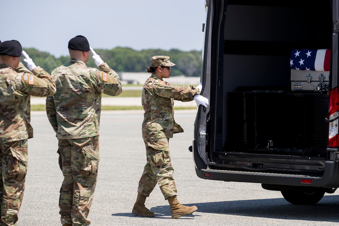 (Alex Brandon  |  AP Photo) Members of an Army carry team salute as Senior Airman Siannie Concepcion closes the doors on a vehicle containing a transfer case containing the remains of U.S. Army Sgt. 1st Class Elliott J. Robbins, at Dover Air Force Base, Del., Tuesday, July 2, 2019. According to the Department of Defense, Robbins, of Ogden, Utah, assigned to the 10th Special Forces Group died while supporting Operation Freedom's Sentinel.