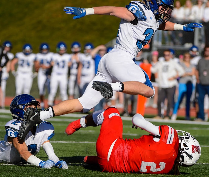 (Trent Nelson | The Salt Lake Tribune)
Pleasant Grove's Porter Connors leaps over East's Tutu Spann (2) as East hosts Pleasant Grove in the first round of the 6A high school football playoffs, Friday Oct. 26, 2018.