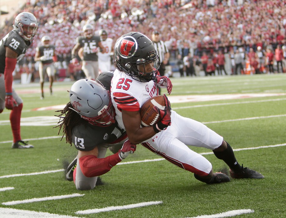 Washington State linebacker Jahad Woods (13) tackles Utah wide receiver Jaylen Dixon (25) during the first half of an NCAA college football game in Pullman, Wash., Saturday, Sept. 29, 2018. (AP Photo/Young Kwak)
