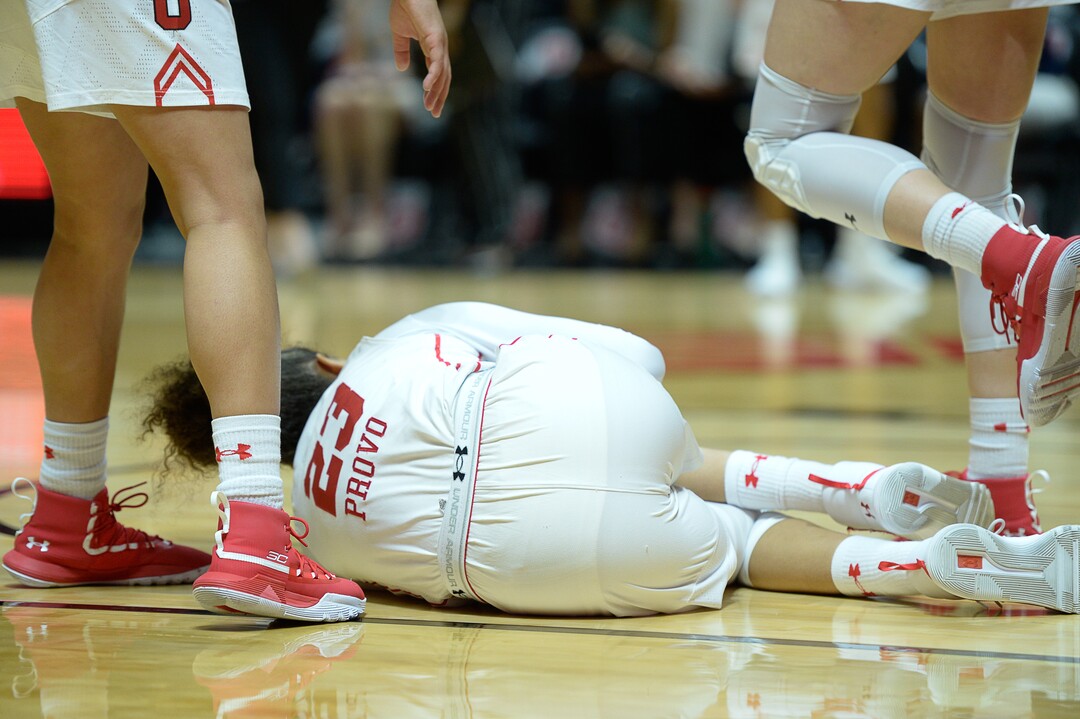 (Francisco Kjolseth  |  The Salt Lake Tribune) Utah Utes guard/forward Daneesha Provo (23) takes a hard hit that injures her knee while battling ASU in Utes' Pac-12 home opener at the Jon M Huntsman Center on Friday, Jan. 4, 2019. Off to one of their best starts in team history, their twelve in a row winning streak came to an end losing to the Sun Devils 63-65.