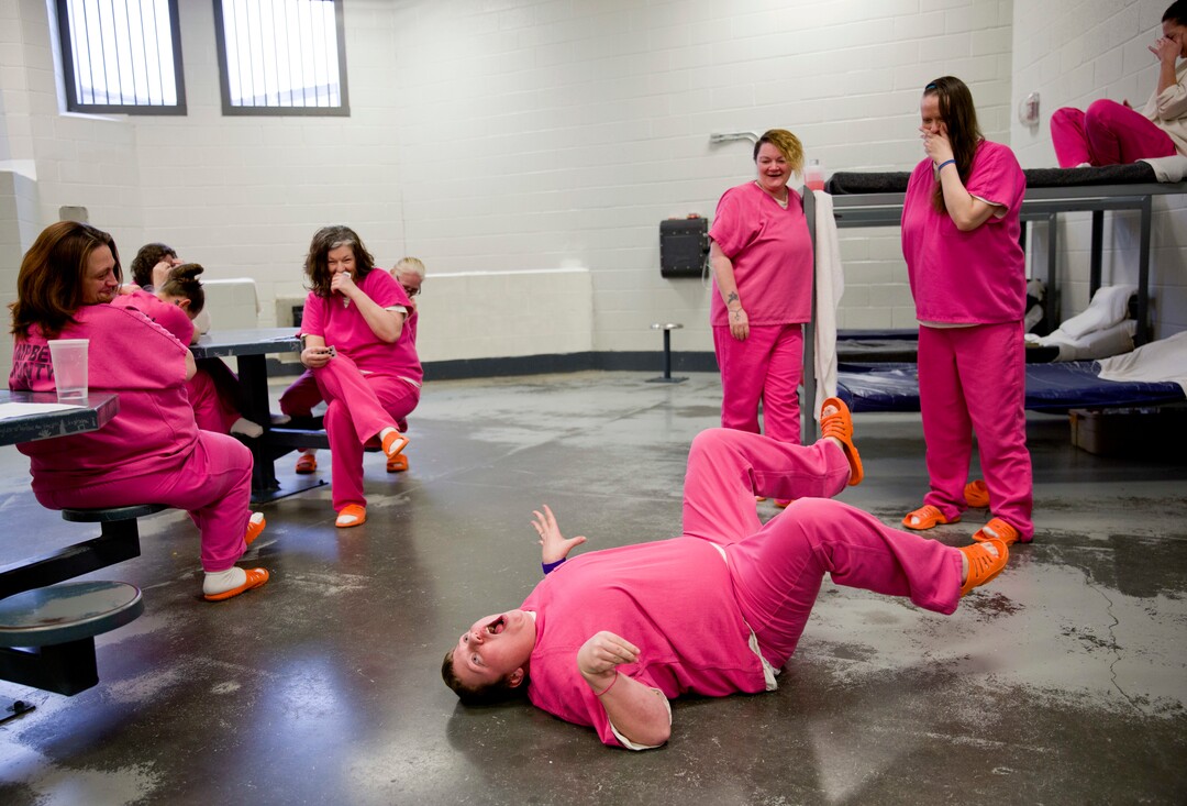 Inmate Blanche Ball, 30, performs her rendition of a turtle on its back for cellmates at the Campbell County Jail in Jacksboro, Tenn., Tuesday, March 20, 2018. Inmates sleep, shower and eat in the same room. On their one hour outside the cell, they can visit an exercise room, but it has no equipment, so the women improvise, rolling toilet paper into balls they swat around, using their plastic sandals as makeshift tennis rackets. (AP Photo/David Goldman)