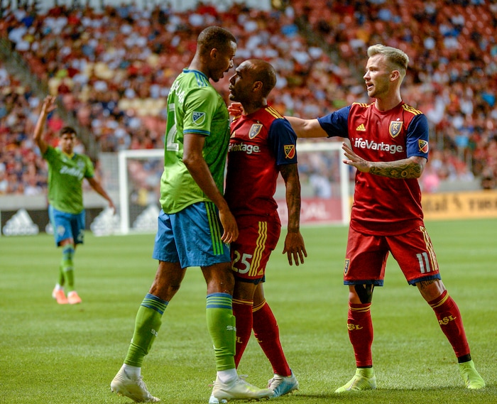 (Leah Hogsten  |  The Salt Lake Tribune) Seattle Sounders defender Saad Abdul-Salaam (12) hits the pitch while battling Real Salt Lake midfielder Everton Luiz (25) for possession as Real Salt Lake hosts the Seattle Sounders, Aug. 14, 2019 at Rio Tinto Stadium in Sandy. RSL defeated the Sounders 3-0.