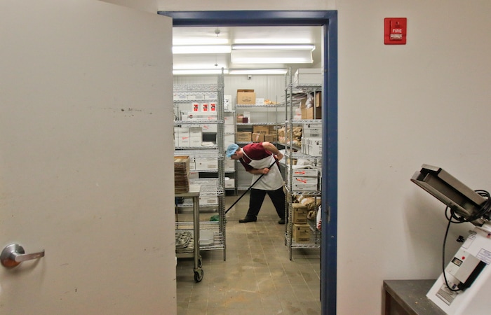 In this Jan. 26, 2018, file photo, John Richins mops a backroom in the kitchen at the Utah County Jail in Spanish Fork, Utah. The Utah County Jail Culinary Arts program utilizes inmates labor in the commercial kitchen. (Evan Cobb/The Daily Herald via AP)