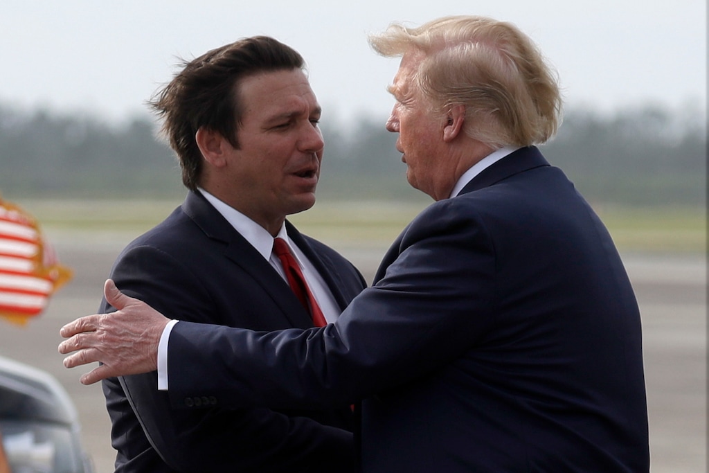 (Evan Vucci | AP) Then-President Donald Trump, right, shakes hands with Florida Gov. Ron DeSantis in 2019 at Tyndall Air Force Base, Fla.