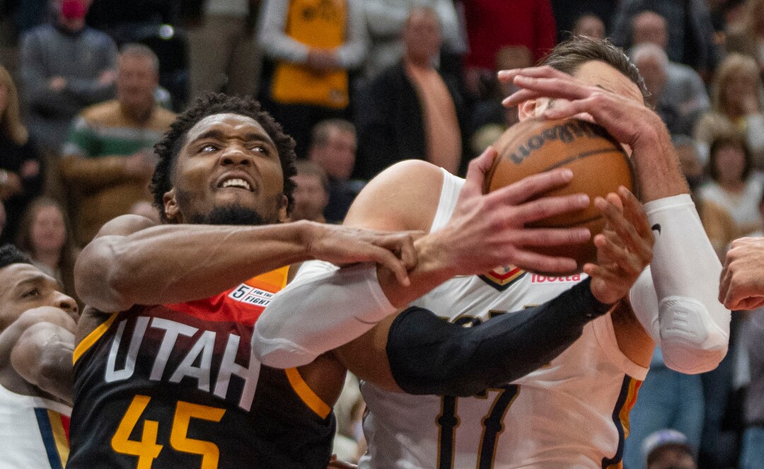 (Rick Egan | The Salt Lake Tribune) Utah Jazz guard Donovan Mitchell (45) battles New Orleans Pelicans center Jonas Valanciunas (17) for a rebound after missing his shot with just seconds left on the clock, in NBA action between the Utah Jazz and the New Orleans Pelicans, at Vivint Arena, in Salt Lake City, on Friday, Nov. 26, 2021.
