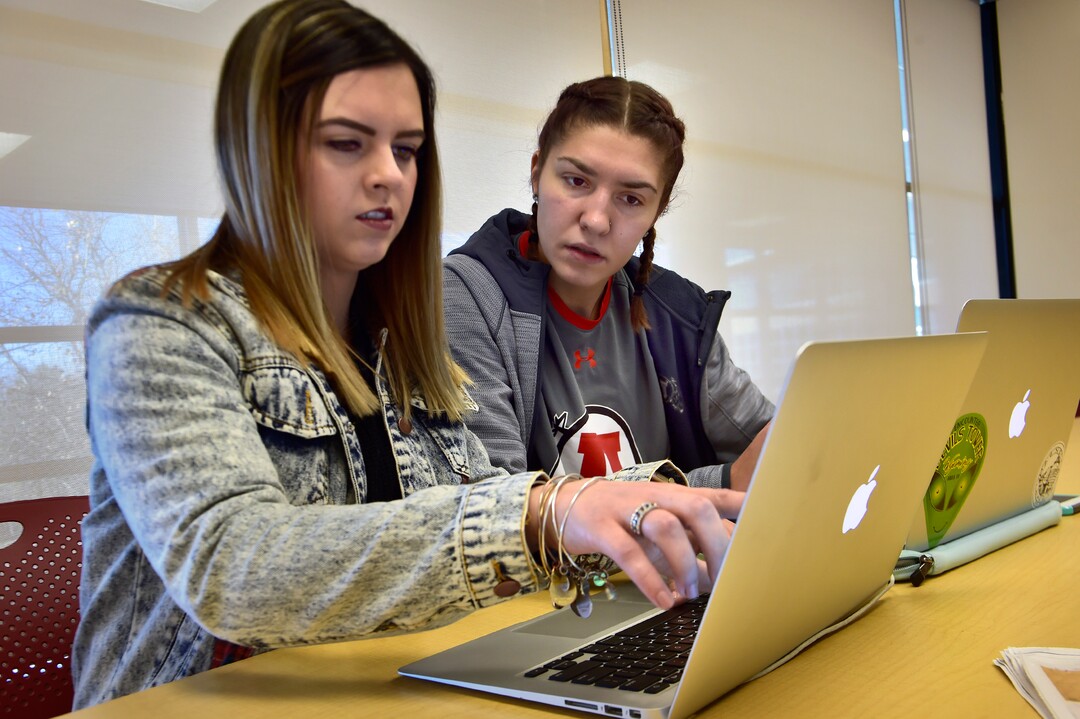 (Scott Sommerdorf   |  The Salt Lake Tribune)   Utah senior star basketball player Emily Potter works on editing a story with Brittni Colindres, left, Wednesday, November 29, 2017. Potter will leave the U with several school records and a shot at the WNBA. She's also a journalism major and works on the sports staff at the Daily Utah Chronicle as a beat writer.