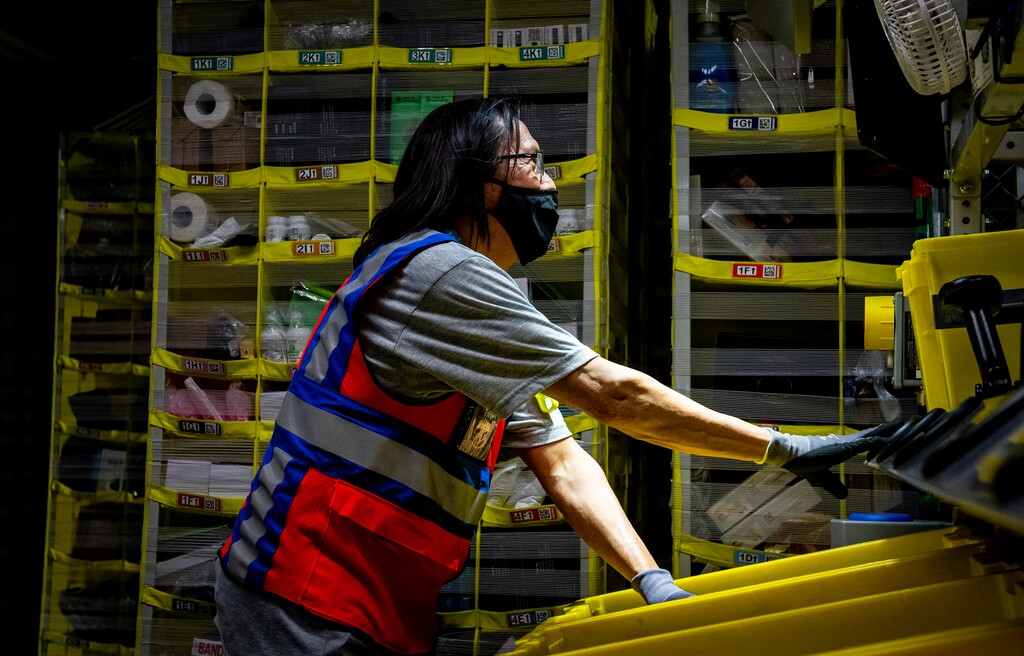 (Isaac Hale | Special to The Tribune) Floor monitor Leo Frazier organizes items during a tour of the Amazon fulfillment center in Salt Lake City on Thursday, June 10, 2021. Frazier previously worked at a ranch in Ogden Valley, but after the coronavirus pandemic hit, he got a job at Amazon.