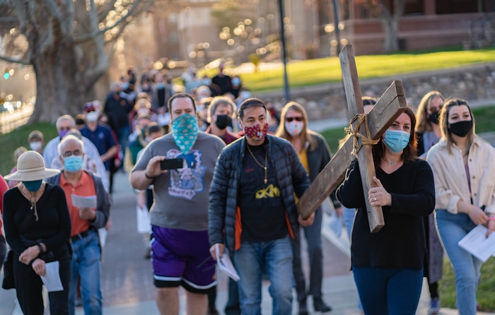 (Francisco Kjolseth | The Salt Lake Tribune) Nawal Zafllow and her husband Julian join other mask wearing Utah Christians as they walk the streets of Salt Lake City beginning at Cathedral of the Madeleine on Good Friday, to symbolically mark Jesus' carrying the cross to his crucifixion, April 2, 2021.