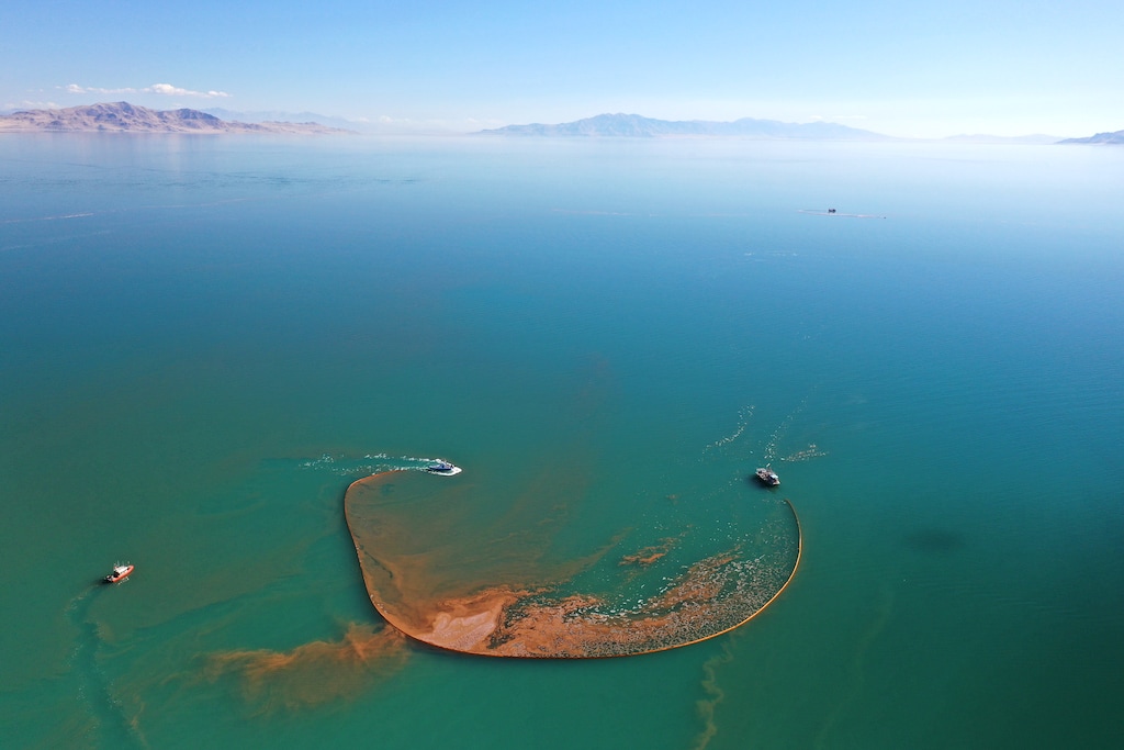 (Great Salt Lake Artemia) Harvest watercraft encircle brine shrimp using containment booms in preparation for harvesting.
