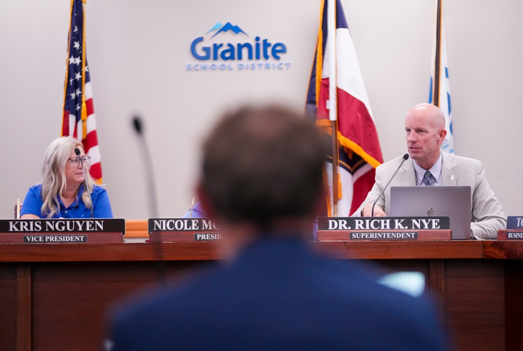(Bethany Baker  |  The Salt Lake Tribune) Granite School District Superintendent Rich Nye, right, speaks after being released from his contract during a special meeting of the district's school board in South Salt Lake on Tuesday, July 9, 2024. The newly selected appointee sits in the foreground.