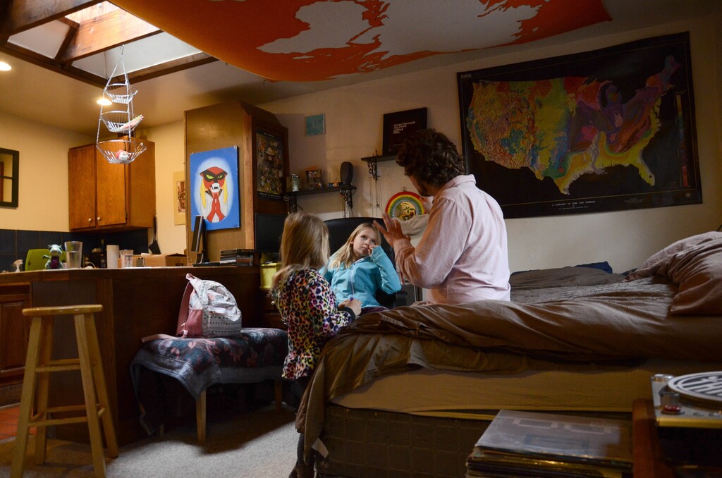 (Tatiana Flowers | AP file photo) In this Tuesday, Nov. 28, 2017 photo, TC Bell sits with his two daughters Dagny, 8 and Emma, 4 before they get dressed for school, at their home in Denver. Bell's daughters are recipients of the Children's Health Insurance Program or CHIP, which is a program that provides low-cost coverage to families who earn too much to qualify for Medicaid. Arizona, California, Colorado, Minnesota, Ohio, Oregon and the District of Columbia are among the first expected to exhaust their CHIP allotments.