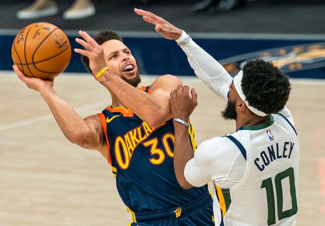 (Rick Egan | The Salt Lake Tribune) Golden State Warriors guard Stephen Curry (30) manages to score and draw a foul as he collides with Utah Jazz guard Mike Conley (10), in NBA action between the Utah Jazz and the Golden State Warriors at Vivint Arena, on  Saturday, Jan. 23, 2021.