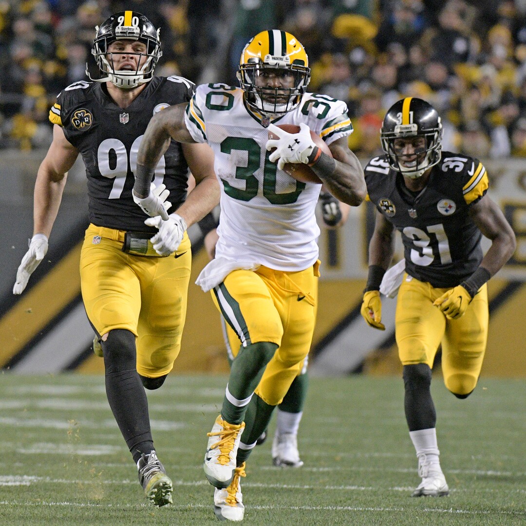 Green Bay Packers running back Jamaal Williams (30) out runs Pittsburgh Steelers outside linebacker T.J. Watt (90) and Mike Hilton (31) to the end zone for a touchdown during the first half of an NFL football game against the Pittsburgh Steelers in Pittsburgh, Sunday, Nov. 26, 2017. (AP Photo/Don Wright)