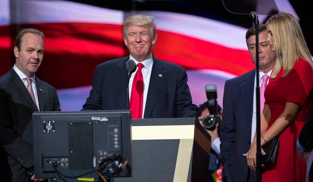 In this July 21, 2016, photo, then-Republican presidential candidate Donald Trump, his daughter Ivanka Trump, then-campaign manager Paul Manafort, second from right, and Rick Gates, left, on stage during a walk through at the Republican National Convention, Thursday, July 21, 2016, in Cleveland. (AP Photo/Evan Vucci)