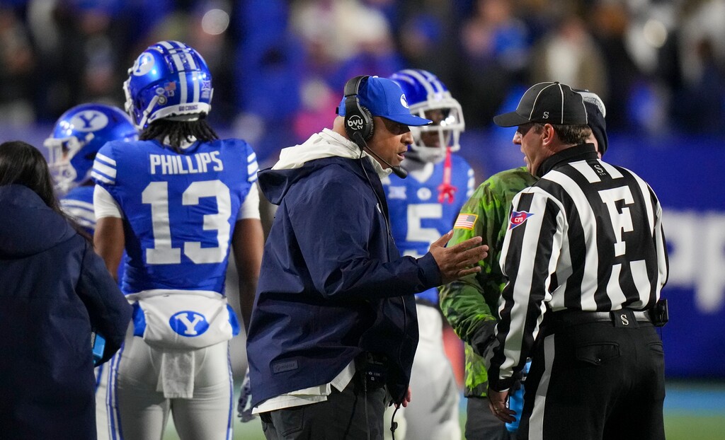 (Bethany Baker  |  The Salt Lake Tribune) Brigham Young Cougars head coach Kalani Sitake speaks with a referee during the game against the Kansas Jayhawks in Provo on Saturday, Nov. 16, 2024.