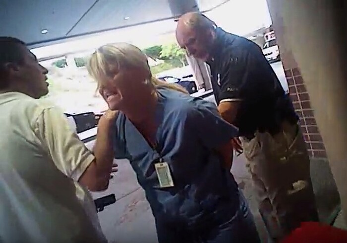 (Salt Lake City Police Department | Courtesy of Karra Porter) In this July 26, 2017, frame grab from video taken from a police body camera and provided by attorney Karra Porter, nurse Alex Wubbels is arrested by a Salt Lake City police officer at University Hospital in Salt Lake City. The Utah police department is making changes after the officer dragged Wubbels out of the hospital in handcuffs when she refused to allow blood to be drawn from an unconscious patient.