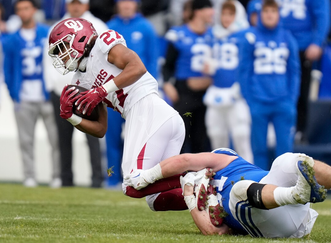 (Bethany Baker  |  The Salt Lake Tribune) Brigham Young Cougars defensive tackle Jackson Cravens (91) tackles Oklahoma Sooners running back Gavin Sawchuk (27) at LaVell Edwards Stadium in Provo on Saturday, Nov. 18, 2023.