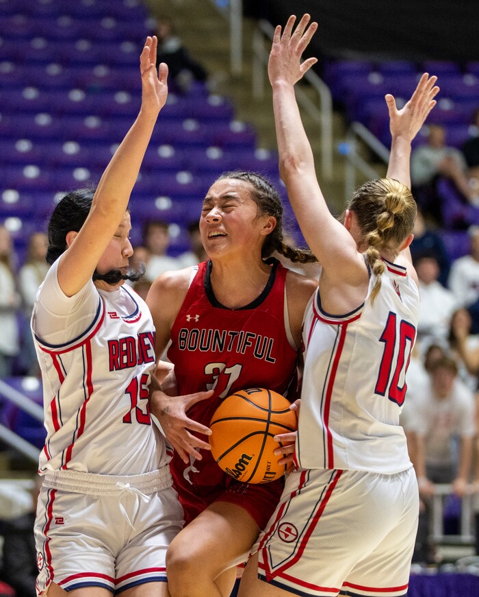 (Rick Egan | The Salt Lake Tribune) Bountiful Redhawks Milika Satuala, tries to split Springville Red Devil defenders Katie Durfey and Kayla  Porray, in the Girls 5A State Championship between the Springville Red Devils and the Bountiful Redhawks, at Weber State, on Saturday, March 4, 2023.
