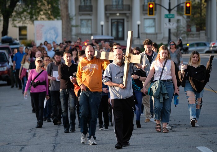 (Francisco Kjolseth  |  The Salt Lake Tribune)  Alex Bury, front, and Kent Kilburn take a turn carrying the cross as christians march through streets of Salt Lake City on Good Friday to symbolically mark Jesus' carrying the cross to his crucifixion beginning at Cathedral of the Madeleine.