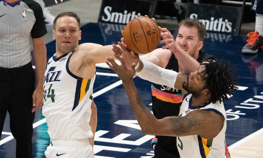 (Francisco Kjolseth | The Salt Lake Tribune) Utah Jazz forward Bojan Bogdanovic (44) and Utah Jazz center Derrick Favors (15) fight for the ball against San Antonio Spurs center Jakob Poeltl (25) in NBA action between the Utah Jazz and the San Antonio Spurs at Vivint Smart Home Arena, on Wednesday, May 5, 2021.