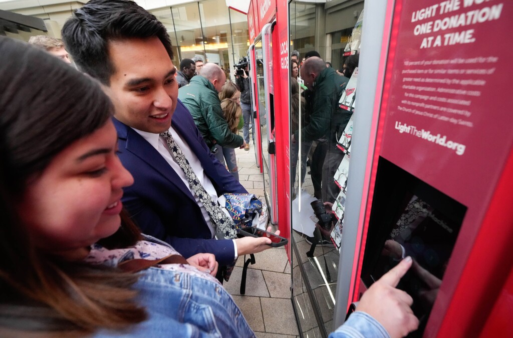 (Francisco Kjolseth | The Salt Lake Tribune) Evelyn Ibarra and her husband, Aaron, make their selection of items to donate in a Giving Machine as The Church of Jesus Christ of Latter-day Saints announces the return of the charity machines installed in the plaza at City Creek Center on Wednesday, Nov. 24, 2021.