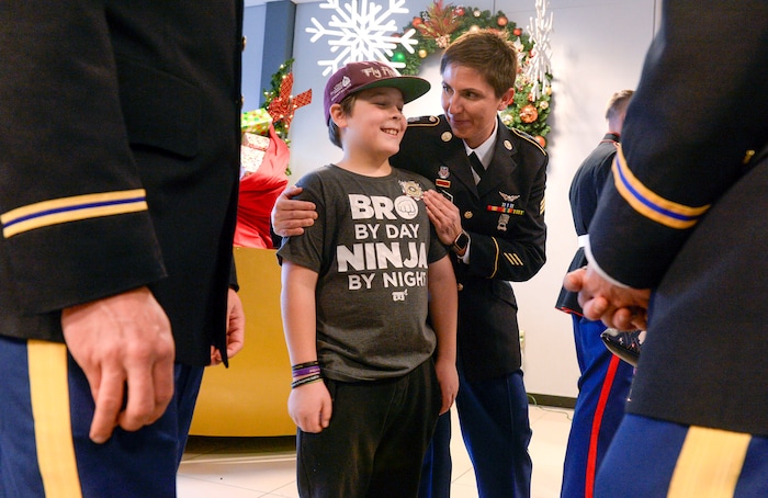 (Leah Hogsten | The Salt Lake Tribune) Brayden Johnson is wished well on his trip by Sgt. Nicole Jajzovic while waiting to board the flight Saturday. Ten Gold Star families from Salt Lake City were treated to a Winter Wonderland scene, including Whoville and the Grinch at their boarding gate at Salt Lake International Airport, Dec. 7, 2019 before their flight to Disney World aboard the Snowball Express. This month, the Gary Sinise Foundation's Snowball Express will fly more than 1,700 family members of fallen U.S. military heroes to Disney World for a holiday retreat.