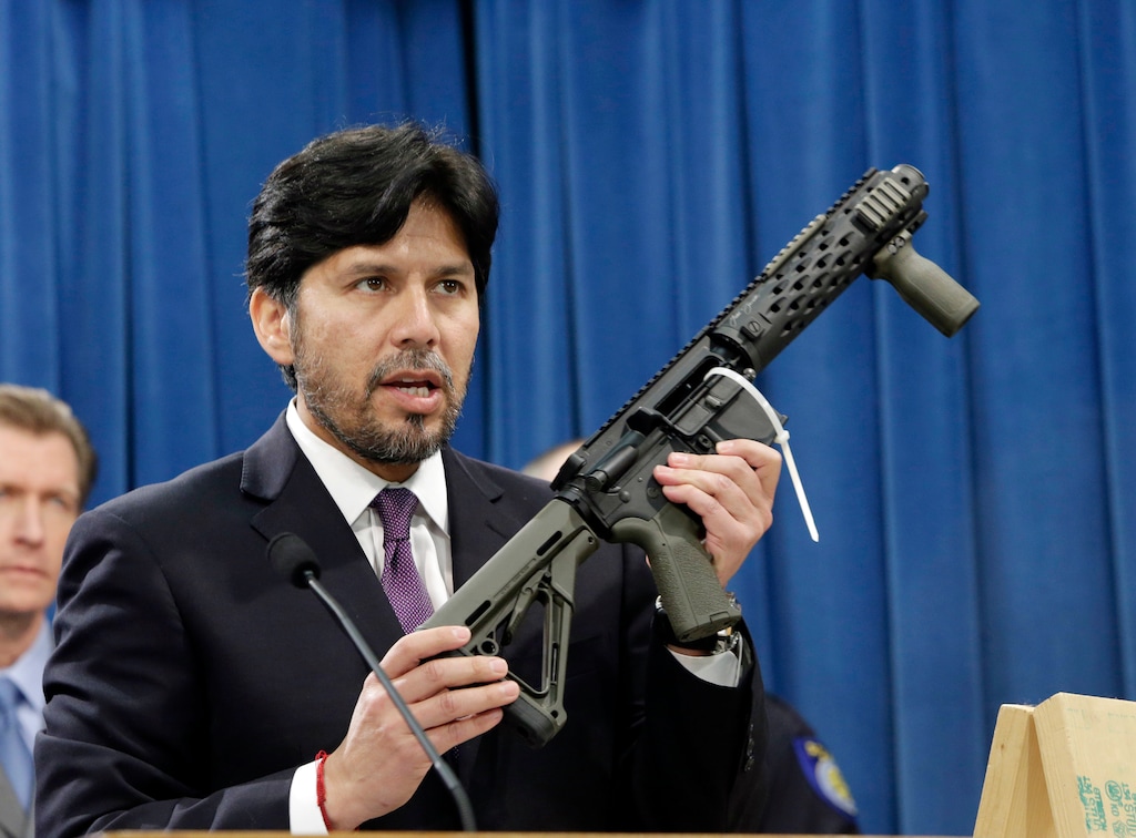 FILE - In this Jan. 13, 2014 file photo, former California State Sen. Kevin de Leon, D-Los Angeles, displays a homemade fully automatic rifle, confiscated by the Department of Justice, at the Capitol in Sacramento, Calif. (AP Photo/Rich Pedroncelli, File)