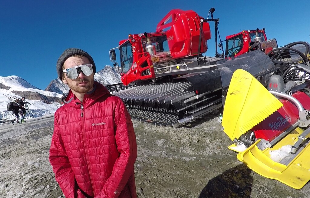 This photo taken from a 4K video and dated Monday, Oct. 16, 2017 shows Jon Lillis, the men's aerial skiing world champion from the United States, posing during an Associated Press interview on the glacier above Saas-Fee, Switzerland. Because snow is no longer guaranteed early in the season at their headquarters in Park City, Utah, she and other members of the US aerials national team went to train high on the Saas-Fee glacier ahead of the 2018 Pyeongchang Olympics. (AP Photo/John Leicester)