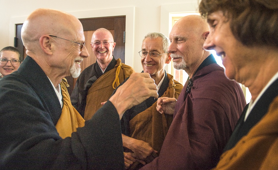 (Leah Hogsten  |  The Salt Lake Tribune) l-r Michael Mugaku Zimmerman Sensei reaches out to Genpo Merzel Roshi for a celebratory hug among fellow roshis after the dedication and eye opening ceremony at Torrey Zendo Meditation Center, Sept. 13, 2017, in Torrey. The Torrey Zendo, founded by Diane Musho Hamilton Sensei and Michael Mugaku Zimmerman Sensei, located near Capitol Reef National Park, had been seasonal but is now a year-round facility for study, practice and retreats.