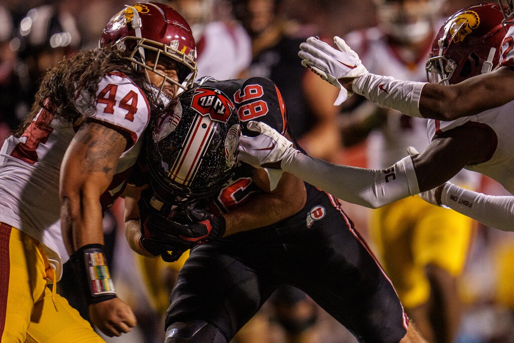 (Trent Nelson  |  The Salt Lake Tribune) Utah Utes tight end Dalton Kincaid (86) slams into USC Trojans linebacker Tuasivi Nomura (44) as the University of Utah hosts USC, NCAA football in Salt Lake City on Saturday, Oct. 15, 2022.