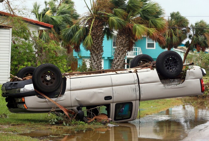 (Gabe Hernandez | Corpus Christi Caller-Times via AP) A dead dog lies out of the passenger window of an overturned pickup truck after Hurricane Harvey landed in the Coast Bend area in Port Aransas, Texas, on Saturday, Aug. 26, 2017. Harvey came ashore Friday along the Texas Gulf Coast as a Category 4 storm with 130 mph winds, the most powerful hurricane to hit the U.S. in more than a decade.