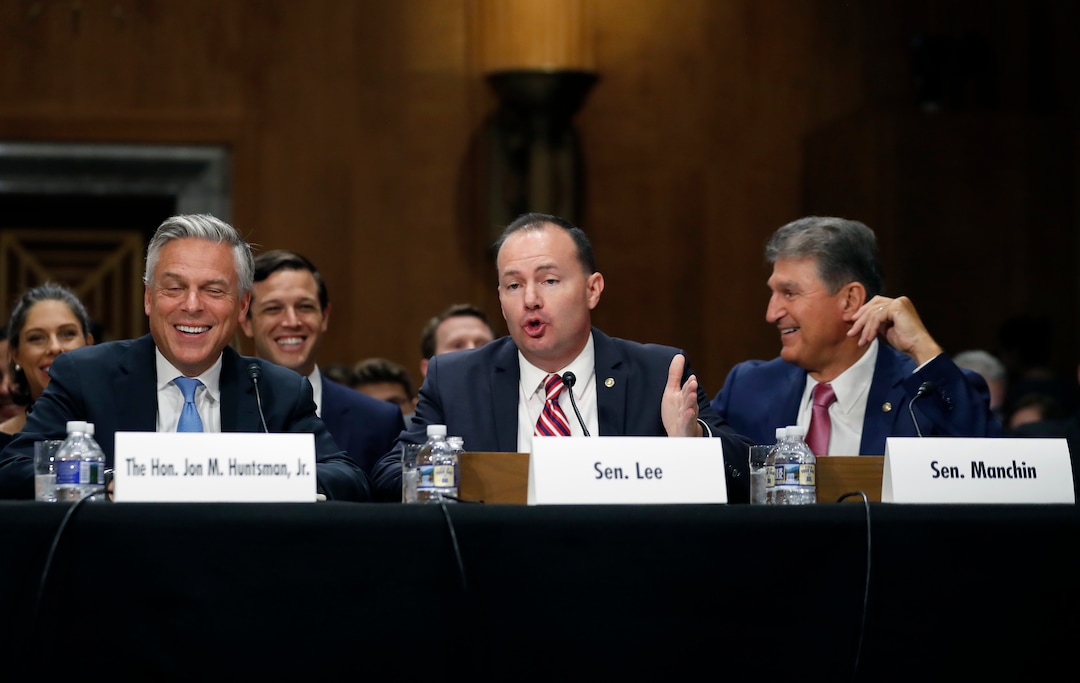 (AP Photo/Alex Brandon) Former Utah Gov. Jon Huntsman, left, laughs as Sen. Mike Lee, R-Utah, speaks, with Sen. Joe Manchin, D-W.Va., right, during a hearing of the Senate Foreign Relations Committee on his nomination to become the US ambassador to Russia, on Capitol Hill, Tuesday, Sept. 19, 2017 in Washington.