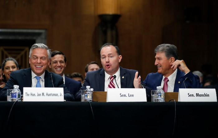 (AP Photo/Alex Brandon) Former Utah Gov. Jon Huntsman, left, laughs as Sen. Mike Lee, R-Utah, speaks, with Sen. Joe Manchin, D-W.Va., right, during a hearing of the Senate Foreign Relations Committee on his nomination to become the US ambassador to Russia, on Capitol Hill, Tuesday, Sept. 19, 2017 in Washington.