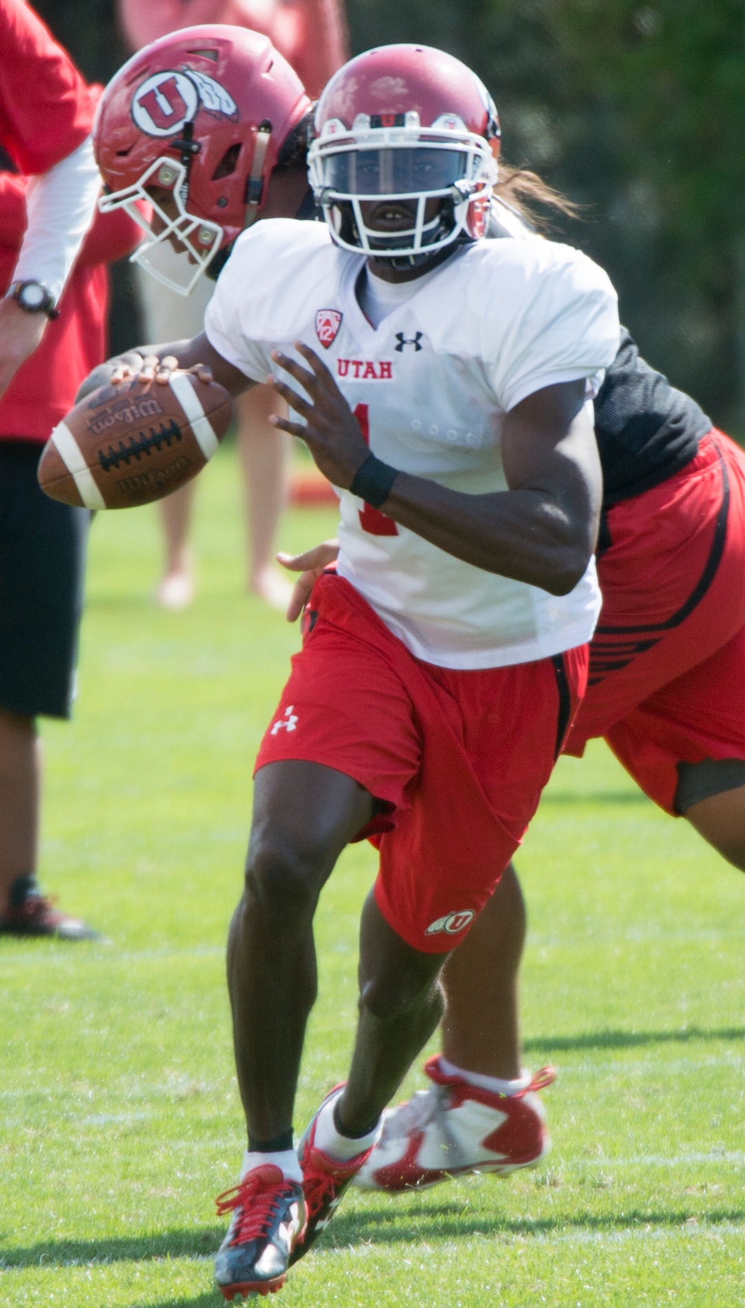 (Rick Egan  |  The Salt Lake Tribune) University of Utah QB Tyler Huntley, (1) runs the ball,  in football practice, Monday, July 31, 2017.