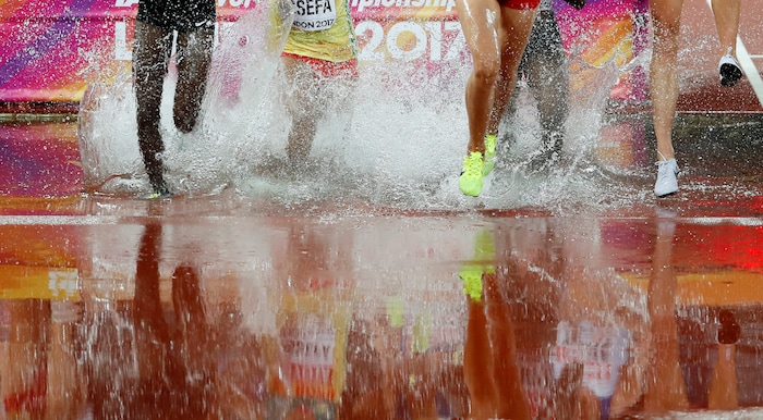 Competitors take the water jump in a Women's 3000m Steeplechase heat during the World Athletics Championships in London Wednesday, Aug. 9, 2017. (AP Photo/Kirsty Wigglesworth)