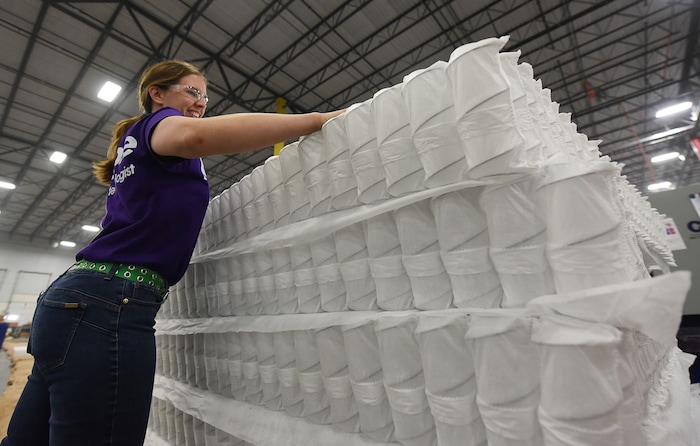 (Francisco Kjolseth | The Salt Lake Tribune)  Malia Spence stacks mattresses of "individual responsive support coils" that make up the core of a line of mattresses for Purple, an Alpine based company that has developed tech to manufacture flexible mattresses at a plant in Grantsville.