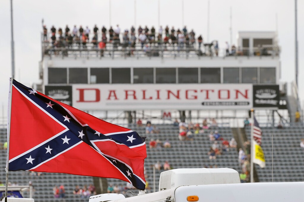 (Terry Renna | AP file photo) A Confederate flag flies in the infield before a NASCAR Xfinity auto race at Darlington Raceway in Darlington, S.C., Sept. 5, 2015. Bubba Wallace, the only African-American driver in the top tier of NASCAR, calls for a ban on the Confederate flag in the sport that is deeply rooted in the South.