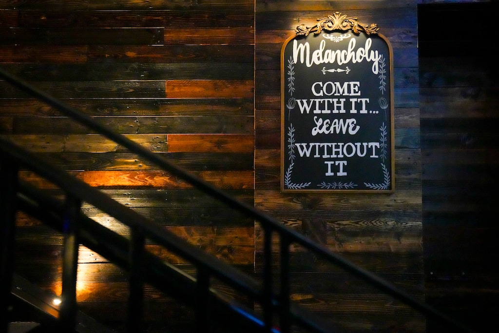(Bethany Baker  |  The Salt Lake Tribune) Art hangs on the wall at Melancholy Wine & Cocktail Lounge in Salt Lake City on Friday, Nov. 22, 2024.