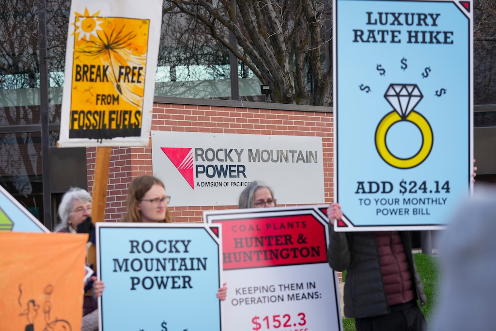 (Bethany Baker | The Salt Lake Tribune) Protesters gather during a Monopoly-themed rally to protest utility-driven rate hikes and obstacles to renewable energy at the corporate headquarters for Rocky Mountain Power in Salt Lake City on Tuesday, April 1, 2025.